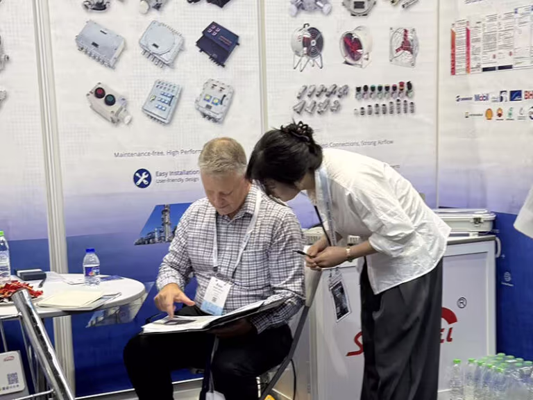 shenhai representative showing product catalog to international buyer at oga 2026